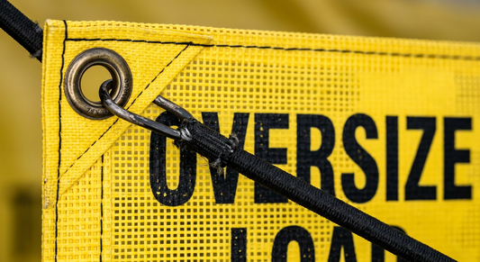 Close up of heavy duty vinyl wide load sign grommets