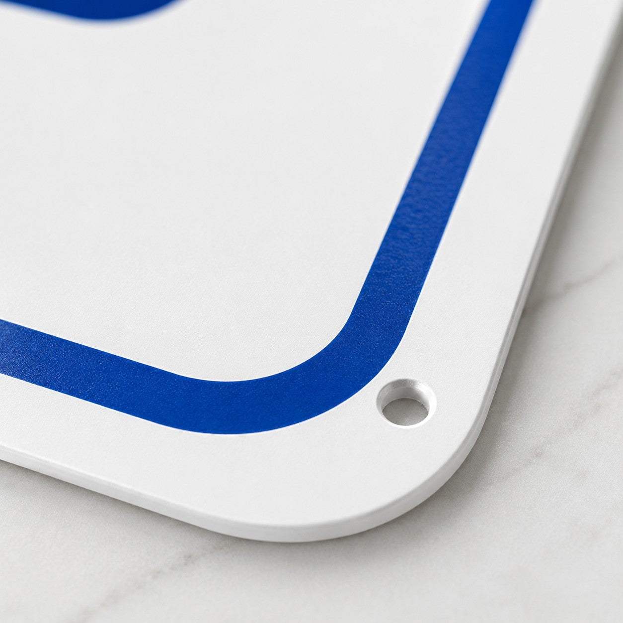 Close up of white aluminum pool sign with rounded corner and pre-drilled mounting hole