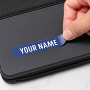 Waterproof name label being applied to a dark case