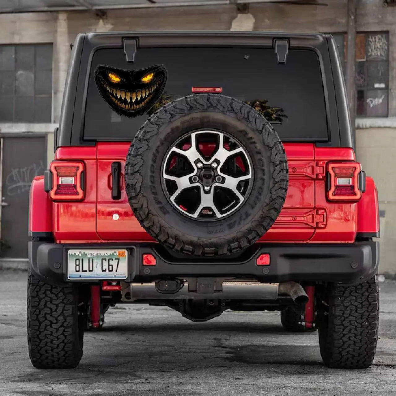 Here are a few options for alt text, keeping under 100 characters:

* **Scary monster face decal on car headlight.**
* **Car 
