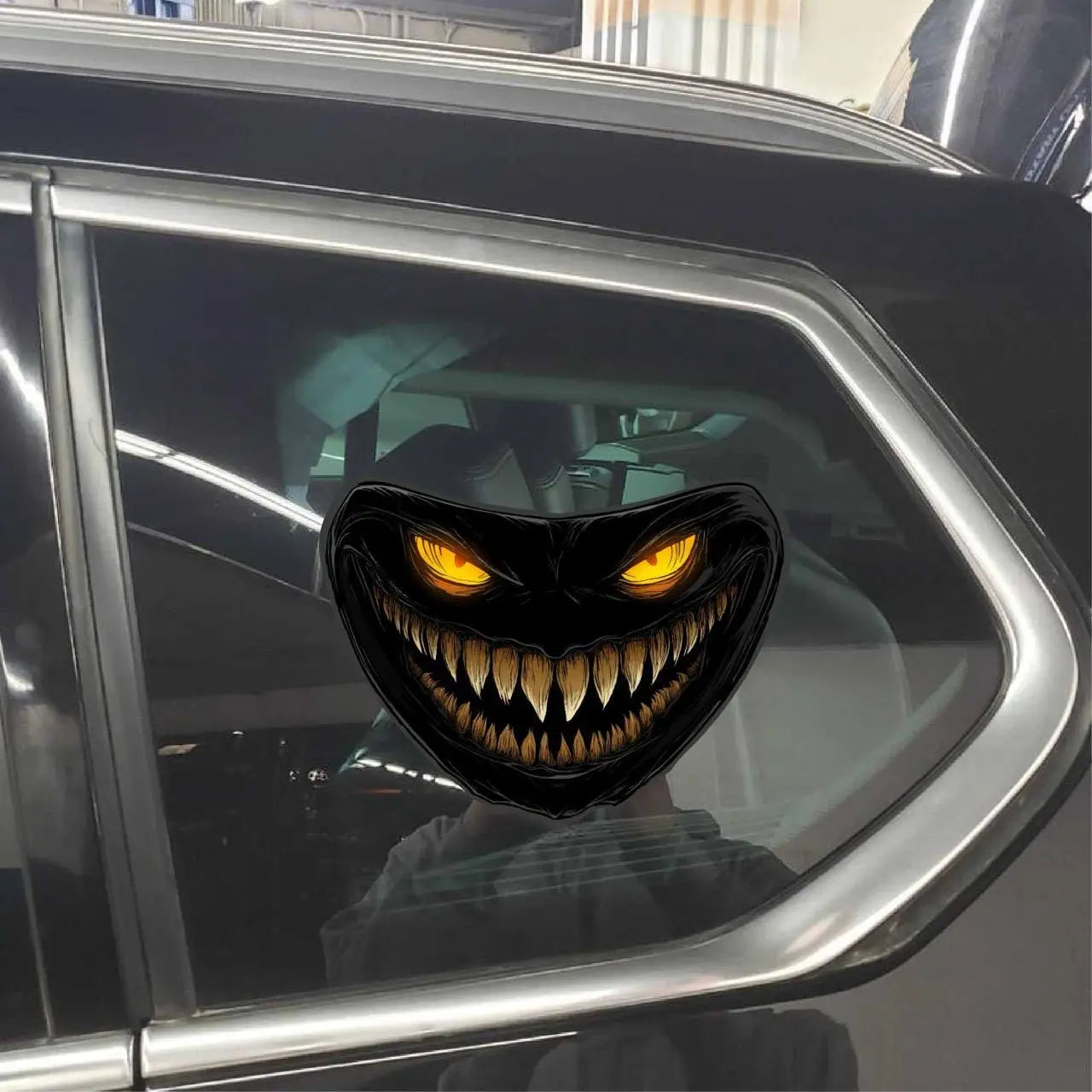 Here are a few options for alt text, keeping under 100 characters:

* **Scary monster face decal on car headlight.**
* **Car 