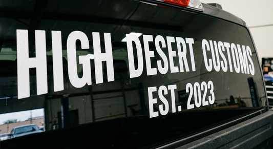 Close-up of custom rear window text decal on a Canadian truck showing crisp edges and finish