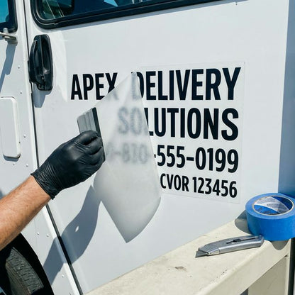 Commercial carrier number decals being installed on a truck door