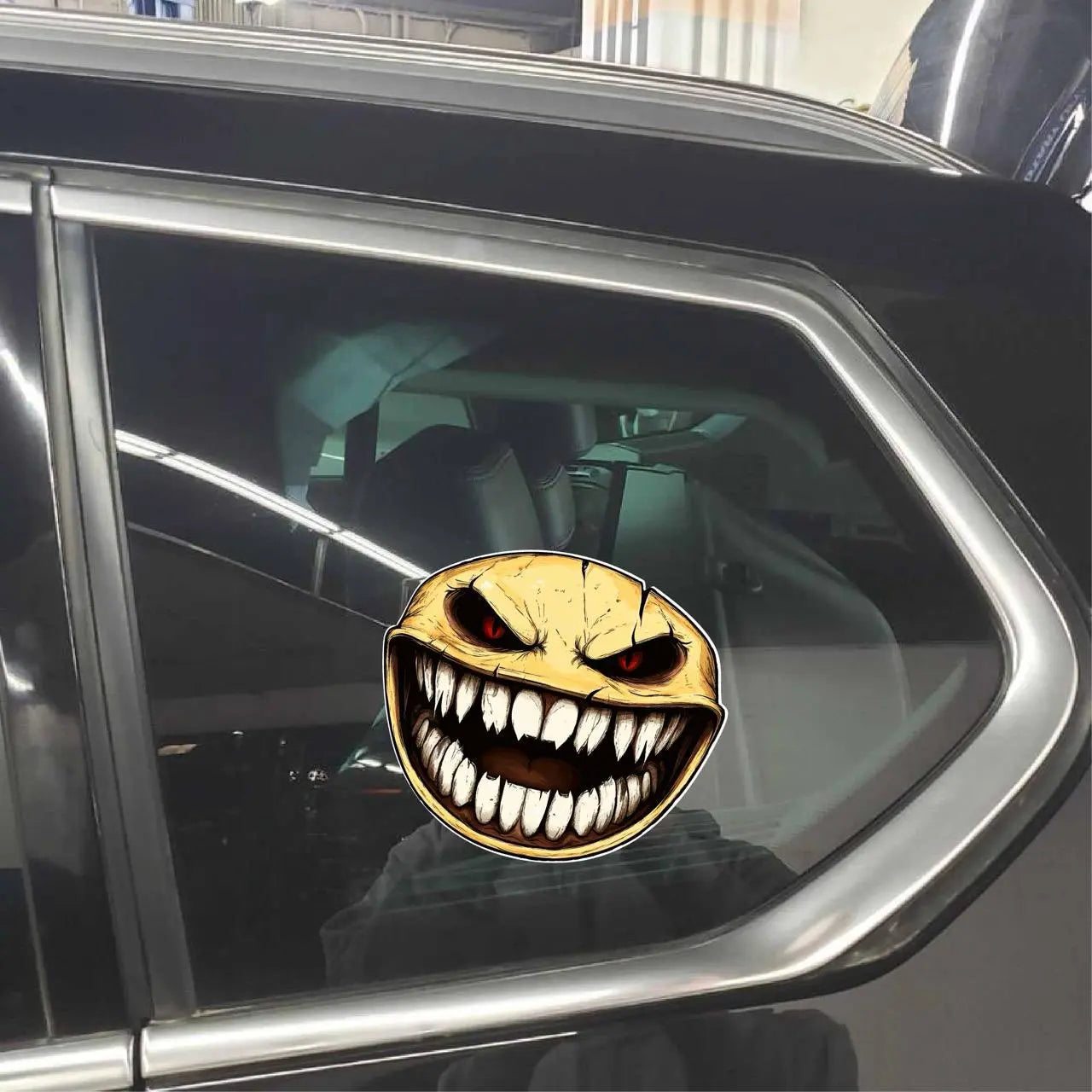 Here are a few options for alt text, keeping under 100 characters:

*   **Scary toothy face sticker on car window.**
*   **Me